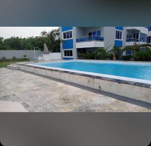 a large swimming pool in front of a building at Luxury Cabarete East Condominiums in Cabarete