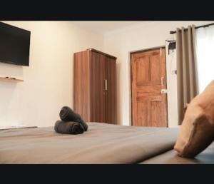 a teddy bear laying on a bed in a bedroom at North39 in Mandrem +18 photos