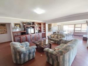 a living room with couches and a coffee table at Linaria Beach House in Britannia Bay