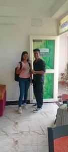 a man and a woman standing in a room at Yuvati Homestay in Bumlitan