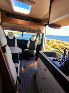a van with a kitchen and a sink in it at Menorca van life in Ciutadella