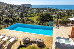 a villa with a pool and a view at The Villino at Cypress Ridge Estate - Stay Waiheke in Onetangi