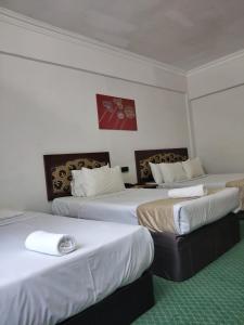Postel nebo postele na pokoji v ubytování Hotel Seri Malaysia Melaka