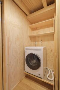 a washer and dryer in a tiny house at SMA MO inn Chitose in Chitose