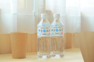 two bottles of water sitting on top of a table at SMA MO inn Chitose in Chitose +18 photos
