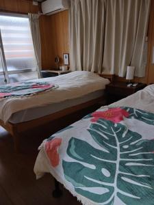 Postel nebo postele na pokoji v ubytování Miyagi Apartment Tomari