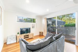 a living room with a couch and a television at Iluka Sea Spray in Iluka