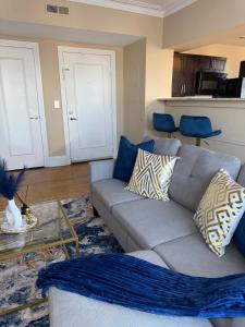a living room with a couch and a table at The Cozy Luxe Retreat, Central West End in Saint Louis