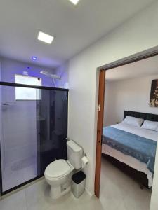 een badkamer met een bed, een toilet en een douche bij Condomínio Residencial Tiê in Camassari