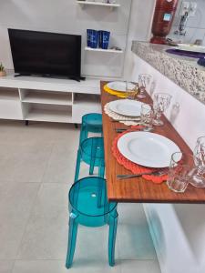 een keuken met een tafel met 2 borden en stoelen bij Condomínio Residencial Tiê in Camassari