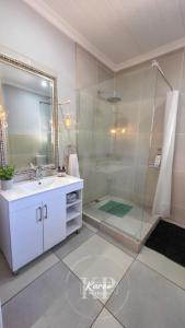 a bathroom with a shower and a sink and a mirror at Die Karoo Patriot in Orania +26 photos
