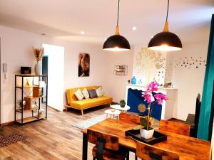 a living room with a table and a couch at Le saphire St Affrique hyper centre ville in Saint-Affrique