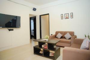 a living room with a couch and a coffee table at Mareenda's Haven in Shillong