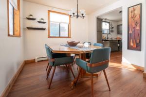 a dining room with a wooden table and chairs at Rustic Mountain Getaway~Golf~Skiing~Hiking in Angel Fire
