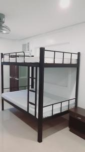 a black bunk bed with a desk in a room at Avana Hills Boracay Prime Traveler's Suite 302 in Boracay