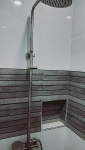 a floor lamp in a room with a bench at Avana Hills Boracay Prime Traveler's Suite 302 in Boracay