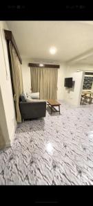 a living room with a couch and a table at TUYU Chhye in Kathmandu