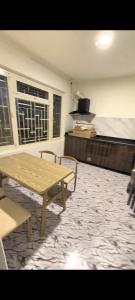 a living room with a table and a bed at TUYU Chhye in Kathmandu