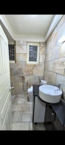 a bathroom with a sink and a toilet at TUYU Chhye in Kathmandu
