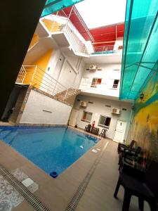 a large indoor swimming pool in a building at Mi Quinta Raíz Loft Apartments in Iquitos