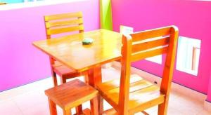 a wooden table and two chairs and a table and a table and chairs at Baan Navy Kohlarn in Ko Larn
