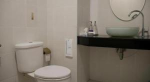 a bathroom with a white toilet and a sink at Sabai @ Chumphae Hotel in Chum Phae +28 photos