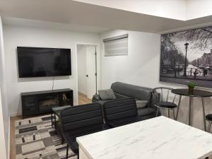 a living room with a couch and a fireplace at Royal Oak in Winnipeg