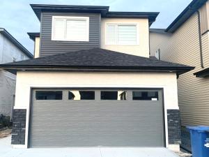 a garage door in front of a house at Royal Oak in Winnipeg