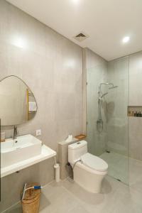 a bathroom with a toilet and a sink and a shower at Villa Buho Ungasan - Luxury Villa 4br in Ungasan
