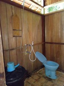 a bathroom with a blue toilet and a shower at " Wobbegong Raja Ampat " in Yennanas Besir