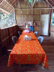 a table in a room with a red table cloth on it at " Wobbegong Raja Ampat " in Yennanas Besir +31 photos