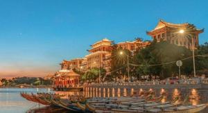 a row of boats in the water in front of a building at Chonpines Hotel North Xiamen Station Jimei University in Xiamen