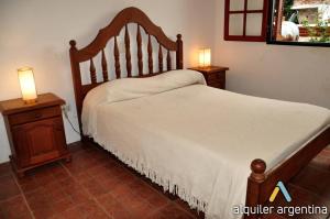 una camera da letto con un letto e due comodini con lampade di Complejo Zara a Villa Carlos Paz