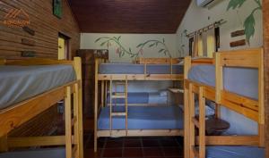 a room with three bunk beds in a cabin at Bungalow Hostel Iguazú in Puerto Iguazú +27 photos