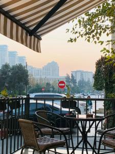 a patio with a table and chairs and a boat at White Breeze Hotel in Baku
