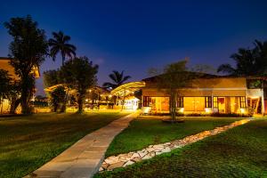 a building with a pathway in front of it at night at Mia Riaan Lake View Resort in Ernakulam