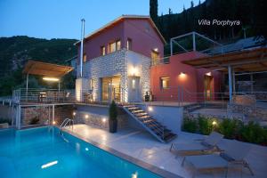 a villa with a swimming pool and a house at Arenaria L. Villas Complex in Lefkada Town