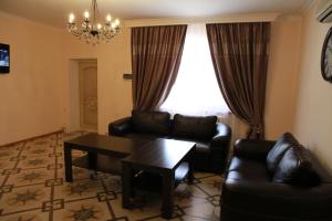 een woonkamer met een bank en een tafel bij Satti in Zharkent