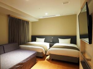 Postel nebo postele na pokoji v ubytování Takatsuki W and M Hotel