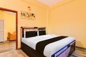 Ένα ή περισσότερα κρεβάτια σε δωμάτιο στο Super Hotel O Birsa Athletics Stadium Formerly De Anmol Suites