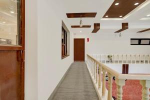 a hallway of a church with a stair case at Hotel O Ashtley Hall Dehradun Formerly Daichi in Dehradun +24 photos