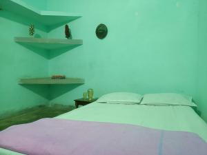 a bedroom with a bed and a clock on the wall at santosh lodge in Muzaffarpur +13 photos