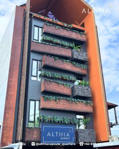 a building with plants on the side of it at Althia Capsule Quarters in Badung