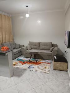 a living room with a couch and a table at 1 bedroom BNB Makutano Meru 06 in Meru