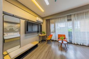 Thank Inn Hotel Hubei Wuhan Caidian Zhong Fa Xincheng Tongji في ووهان: غرفة في الفندق مع أريكة وطاولة وسرير