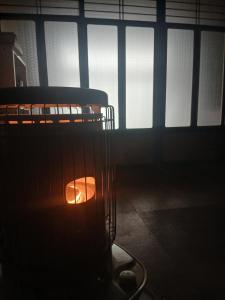 a candle in a cage in a dark room at Homestay民泊月読庵 in Tottori