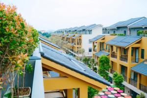 a row of houses with solar panels on their roofs at Wyndham Lynn Times Thanh Thủy Onsen Sweet Home in La Phu