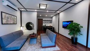 a living room with a couch and a table at Wyndham Lynn Times Thanh Thủy Onsen Sweet Home in La Phu