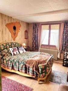 Ένα ή περισσότερα κρεβάτια σε δωμάτιο στο les gites du verger