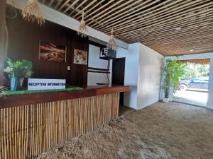 a lobby with a reception counter and a window at Kimura Beachfront Villas El Nido in El Nido